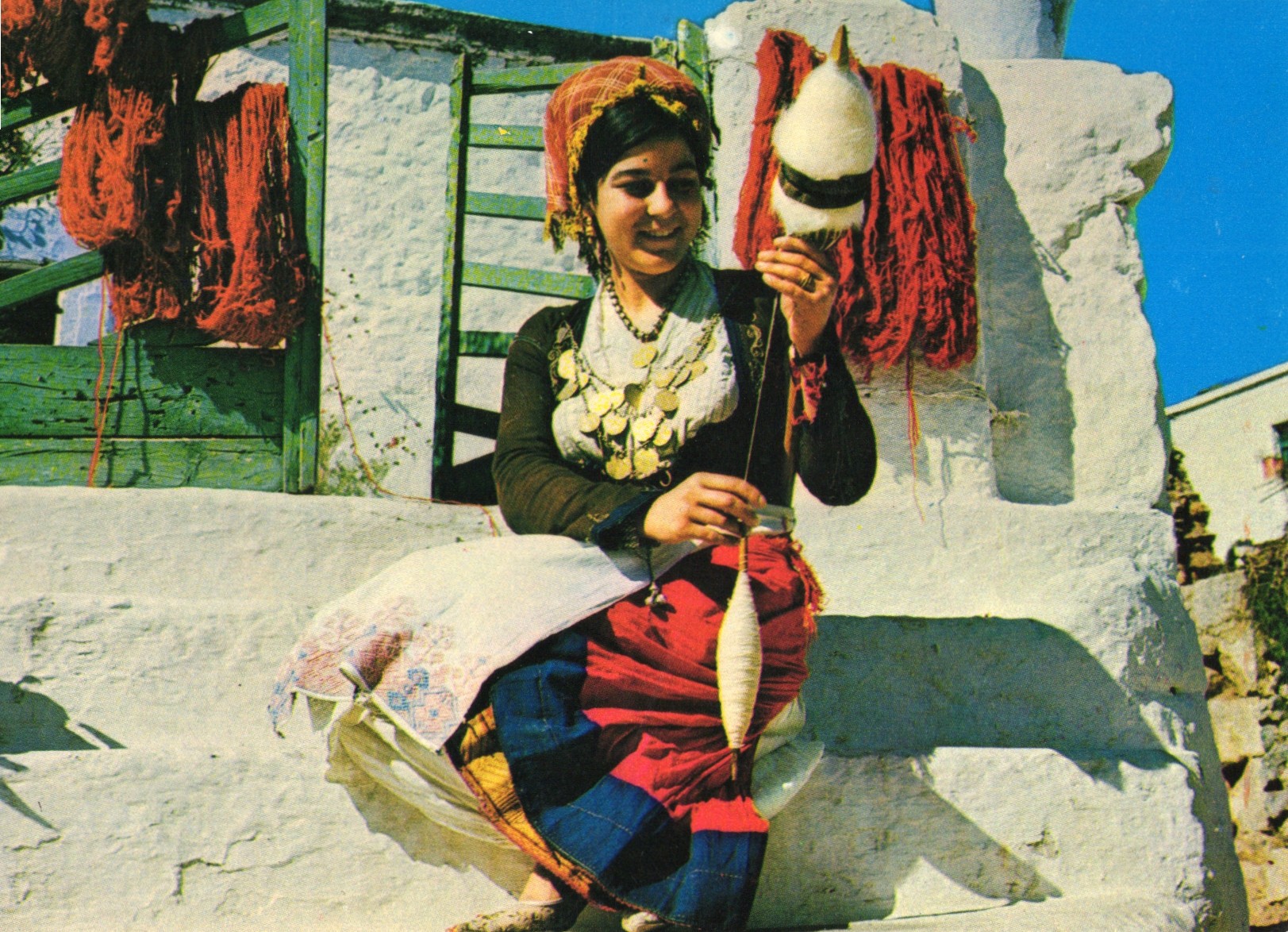 Young girl from Crete spinning wool in the traditional way artifact